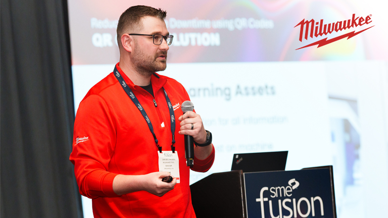 Milwaukee Tool team member in red shirt speaks in front of a crowd at Mission Critical 2030