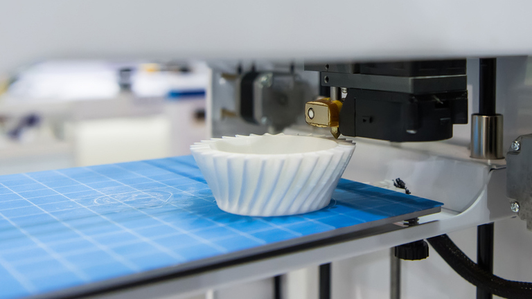 Additive manufacturing creating a part