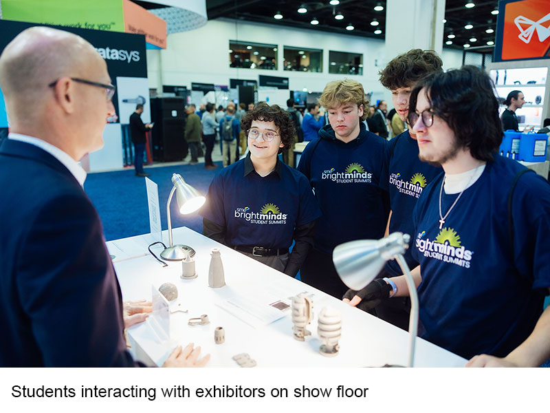 Students interacting with exhibitors on show floor